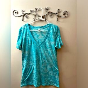 Next Level Apparel Size XL (fits like a Large) Teal and see through.